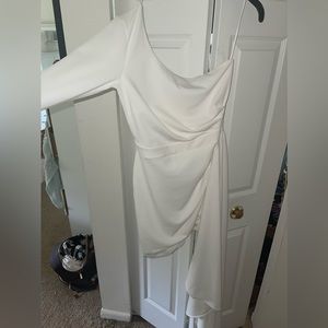 White formal dress. One long sleeve with the opposite side draped to floor.